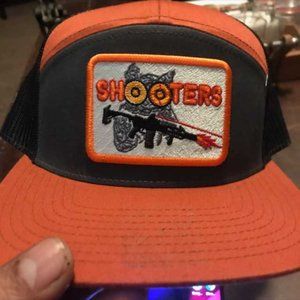 Black and orange Shooters trucker hat
